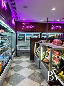 a grocery store with neon signs on the walls at Bel Air -- Sea View Studio in Ras al Khaimah