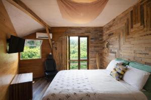 a bedroom with a bed and a television in it at Casa Rover - Floripa in Florianópolis +97 photos