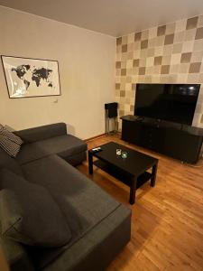 a living room with a couch and a coffee table at Central accommodation in Umeå
