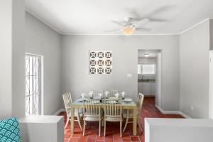 a dining room with a table and chairs at Palasette Dover Gardens Barbados in Christ Church +7 photos