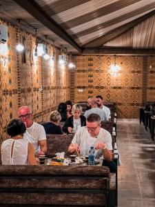 a group of people sitting at a table in a restaurant at Victoria Luxury camp in Wadi Rum
