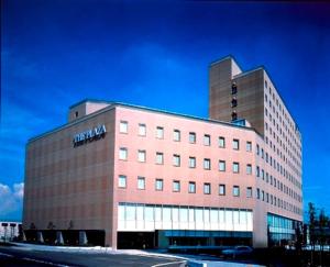 a large building with a sign on the side of it at Hotel Plaza Kachigawa in Kasugai