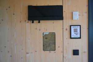 a wooden wall with a plaque and a sign on it at Tiny House Pioneer 5 - Green Tiny Spot Schillig in Wangerland
