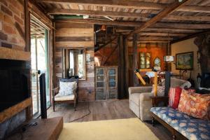 a living room with a couch and a fireplace at Casa Rover - Floripa in Florianópolis