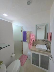 a bathroom with a sink and a toilet and a mirror at Sweethome Mérida in Mérida +14 photos