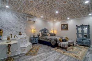 a bedroom with a king sized bed and a bath tub at McMillan Inn in Savannah