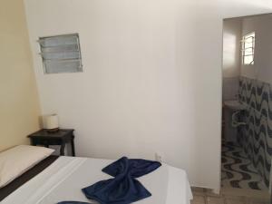 a bedroom with a bed with a blue bow on it at Suite Quadrupla Terreo Oceazul in Conde +5 photos