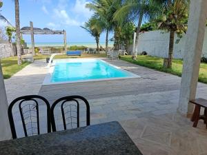 a swimming pool with a view of the ocean at Suite Quadrupla Terreo Oceazul in Conde