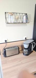 a kitchen counter with a toaster and a toaster and a toaster at Gite Les 4 Moustaches in Bourbourg