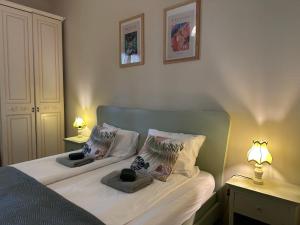 a bedroom with two beds with two lamps on them at il nuvoloso 2 in Città della Pieve