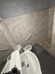 a bathroom with a white toilet and a sink at Nid Garona in Carbonne +6 photos
