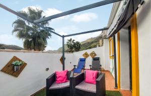 a balcony with chairs and a view of the mountains at La Escapadita in Benaoján