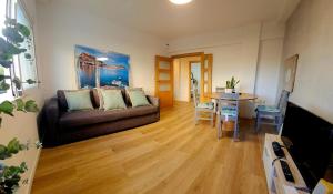 a living room with a couch and a table at Postiguet Beach 2 garajes SuperHost SuperFlat in Alicante