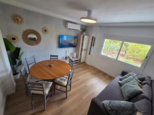 a living room with a table and a couch at Postiguet Beach 2 garajes SuperHost SuperFlat in Alicante