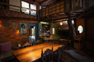 a large wooden table in a room with chairs at Casa Rover - Floripa in Florianópolis