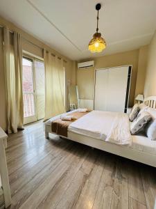 a bedroom with a large bed and wooden floors at Boutique Hotel Meidan View in Tbilisi City