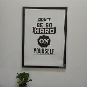 a picture of a frame on a wall with a poster at StaySpace in Graz