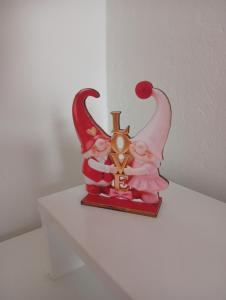 a statue of two angels sitting on a shelf at StaySpace in Graz +1 photo