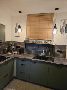 a kitchen with a sink and a counter top at Apartmán GREEN in Vysoké Mýto +28 photos