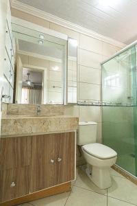 a bathroom with a toilet and a sink and a shower at Casa Atlântida in Xangri-lá +20 photos