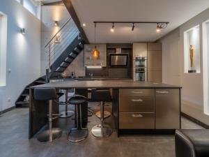 a kitchen with a large island with bar stools at LE LOFT 67 in Strasbourg