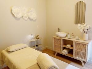 a bathroom with a bed and a sink and a mirror at Lodges Minho in Ponte da Barca