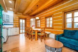 a living room with a blue couch and a table at Roubenka Pastvina in Rudník
