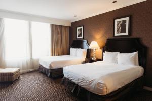 a hotel room with two beds and a window at Hotel Julien Dubuque in Dubuque +37 photos