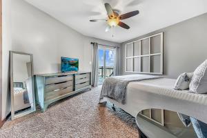 a bedroom with a bed and a ceiling fan at Bridges Bay Vacation Cabin 278 in Arnolds Park +36 photos
