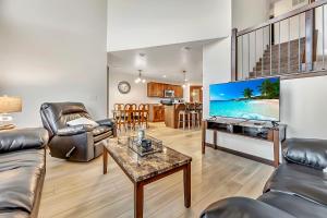 a living room with a tv and a couch and a table at Bridges Bay Vacation Cabin 278 in Arnolds Park