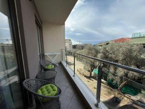 a balcony with three chairs with tennis balls in them at Modern Apartment with Balcony in Przno - Near Beach in Pržno