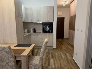a kitchen with a table and chairs in a room at Modern Apartment with Balcony in Przno - Near Beach in Pržno