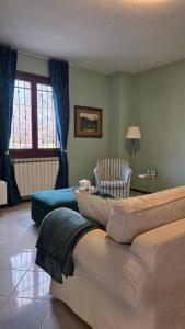 a bedroom with two beds and a chair in a room at Al Melograno - Villetta - Gussago - Franciacorta in Gussago