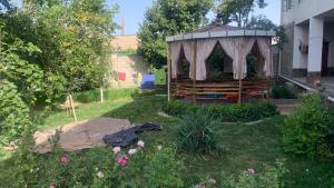 a garden with a gazebo in the yard at Salom Hostel in Panjakent