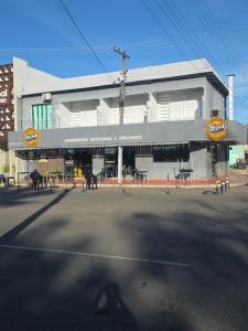 a large white building with a sign for a restaurant at Trilhas do Araguaia in Aruanã