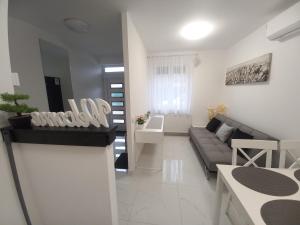 a living room with a couch and a table at JULIANNA APARTMAN Budapest FREE PARKING in Budapest