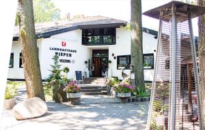 a white building with trees and flowers in front of it at Rooms by Ruhrpadel in Gladbeck