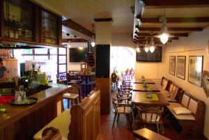 a restaurant with tables and chairs and a bar at Rooms by Ruhrpadel in Gladbeck