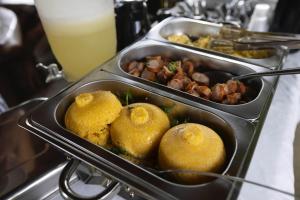 two trays of food on top of a buffet at Pousada Mandacaru, próximo a Usina de Arte in Campestre +6 photos