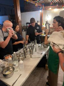 a group of people standing around a table in a kitchen at Casa Huaca in Lima +25 photos