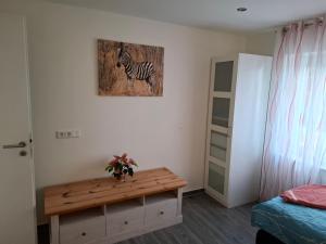 a room with a picture of a zebra on the wall at Ferienwohnung bei Rheine Neubau 2026 mit Klima Terrasse ruhige Lage in Neuenkirchen +21 photos