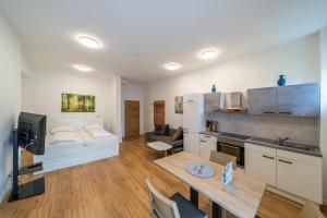 a kitchen and living room with a couch and a table at Ferienwohnungen Hebalm in Pack