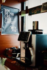 a sign that says how do you like your coffee at Sunset Lake hostel in Ohrid