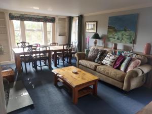 a living room with a couch and a table at Hawks Nest in Selkirk