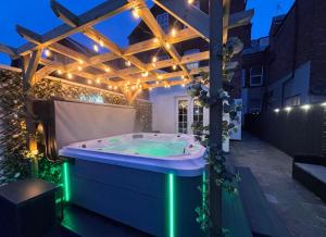 a jacuzzi tub in a backyard with lights at Lethbridge Villa 49 3-bedroom Apartment with private HOT TUB,Fibre WiFi, free parking, sleeps 6 in Southport