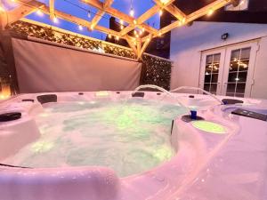 a hot tub with green lights in a room at Lethbridge Villa 49 3-bedroom Apartment with private HOT TUB,Fibre WiFi, free parking, sleeps 6 in Southport