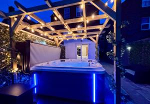 a jacuzzi tub under a pergola at night at Lethbridge Villa 49 3-bedroom Apartment with private HOT TUB,Fibre WiFi, free parking, sleeps 6 in Southport