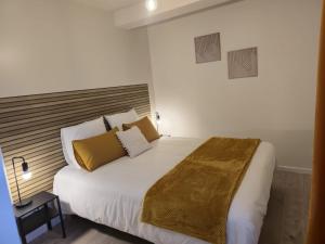 a bedroom with a large bed with yellow pillows at Domaine de Zely in Fontaines-dʼOzillac