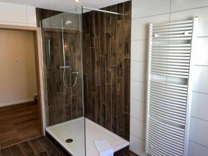 a shower with a glass door in a bathroom at City Apartments, Outlet 100 Meter in Metzingen +11 photos