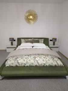 a bedroom with a bed with a gold mirror on the wall at Vamesu Frontiers - Luxury borders in Sibiu